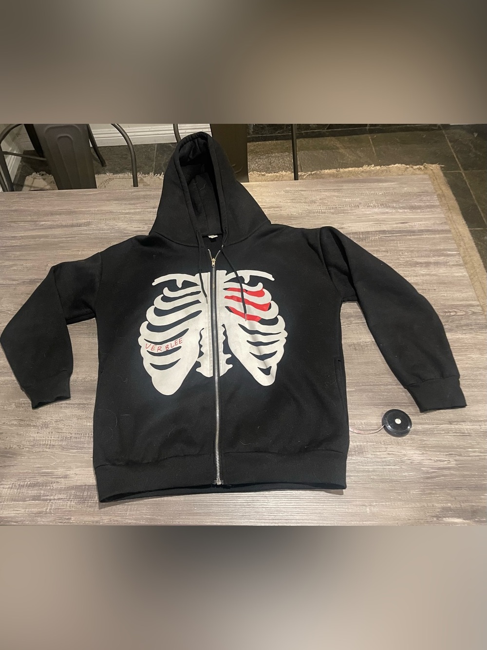 Black Zip-Up Hoodie with White Ribcage Graphic and Red Accent